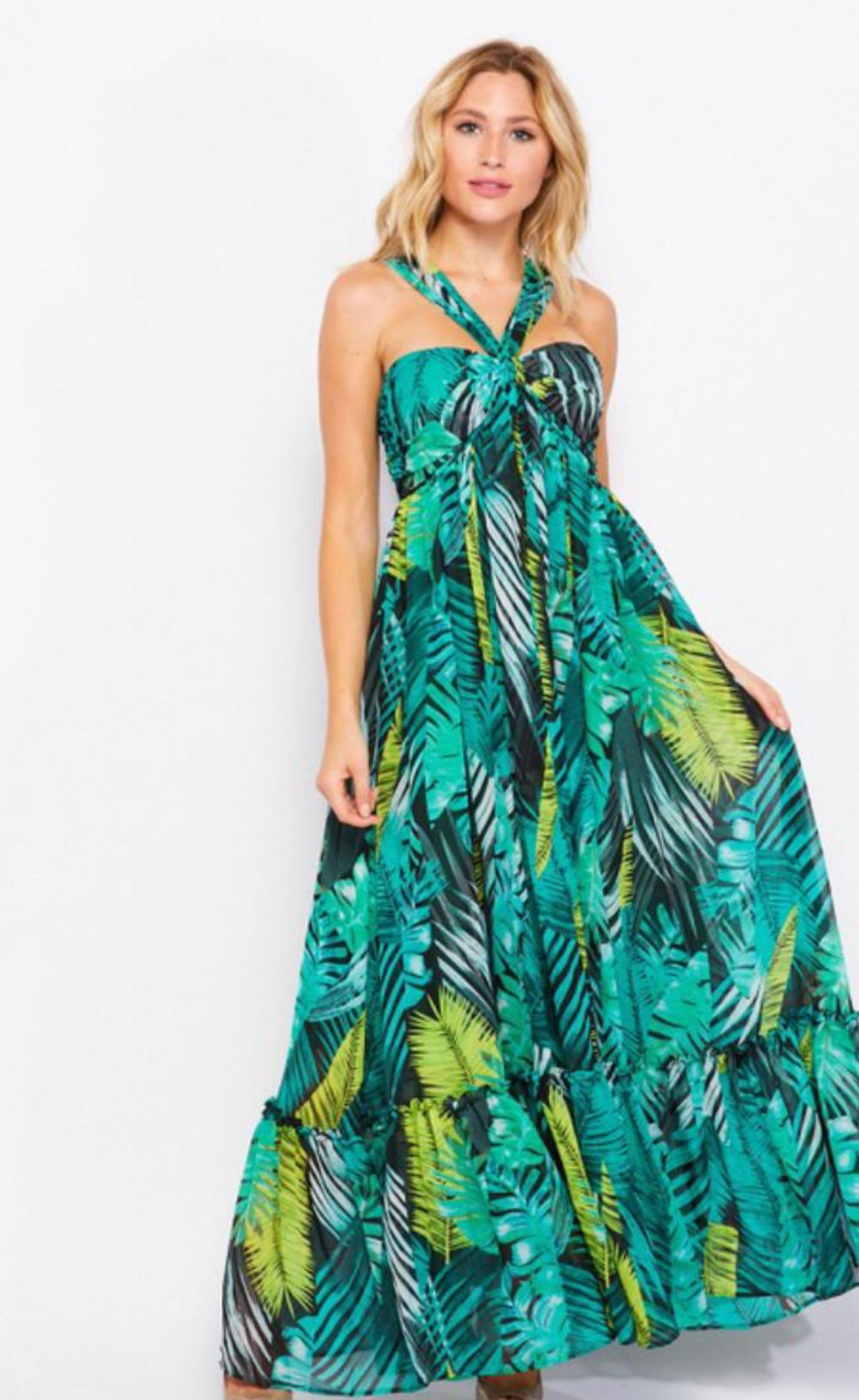 Woman wearing a green and yellow floral dress on a white background