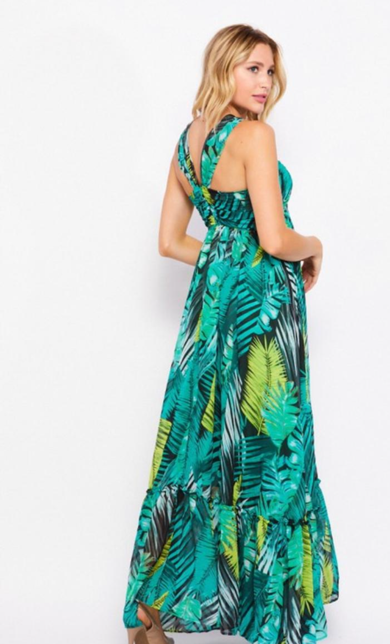 Woman wearing a green floral dress on a white background