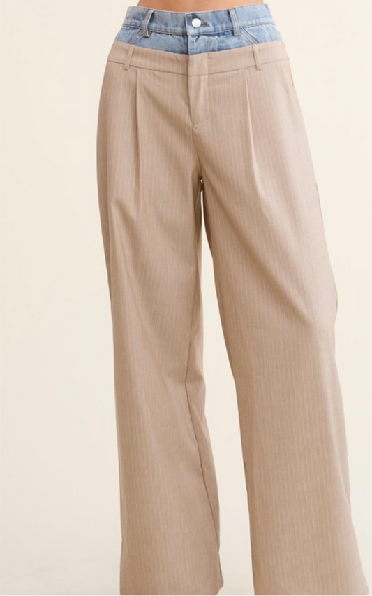 Beige pants with a blue denim waistband on a beige background