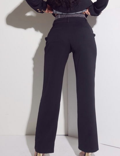 Person wearing black high-waisted pants against a white background