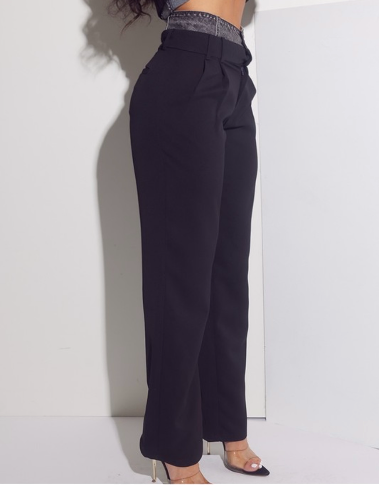 Person wearing dark pants against a white background